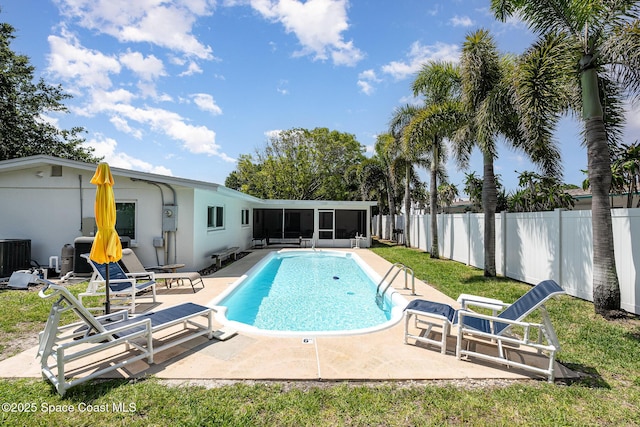 8103 Magnolia Ave, Cape Canaveral, FL 32920 - view of swimming pool featuring a sunroom, a fenced backyard, a patio area, and central AC