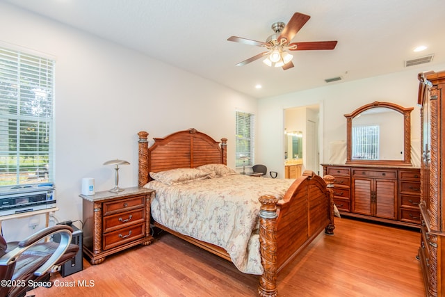 7030 Livingstone Ln, Melbourne, FL 32904 - bedroom with light wood-style flooring, multiple windows, ensuite bathroom, and recessed lighting