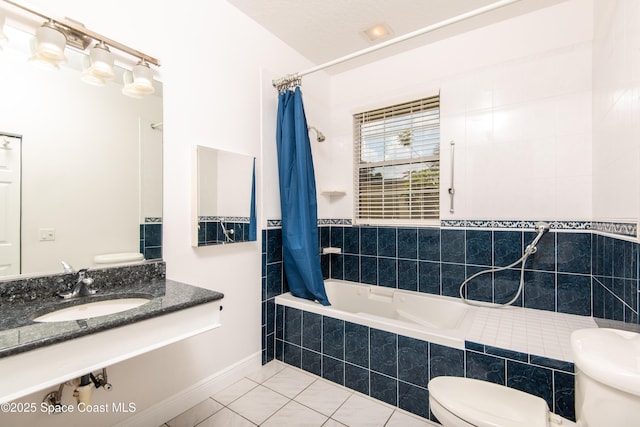 7030 Livingstone Ln, Melbourne, FL 32904 - full bath with a sink, toilet, tiled shower / bath, baseboards, and tile patterned floors