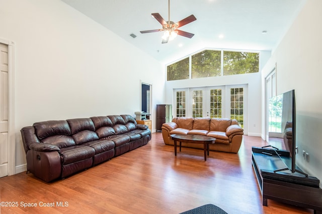 7030 Livingstone Ln, Melbourne, FL 32904 - living room with high vaulted ceiling, ceiling fan, and wood finished floors