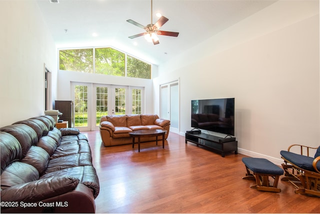 7030 Livingstone Ln, Melbourne, FL 32904 - living area featuring ceiling fan, high vaulted ceiling, wood finished floors, and french doors