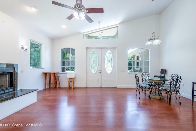 7030 Livingstone Ln, Melbourne, FL 32904 - entryway with wood finished floors, vaulted ceiling, a premium fireplace, and a ceiling fan