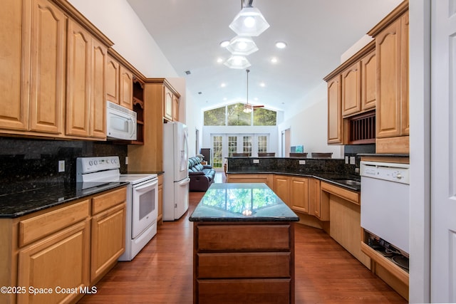 7030 Livingstone Ln, Melbourne, FL 32904 - kitchen featuring white appliances, vaulted ceiling, tasteful backsplash, a peninsula, and dark wood finished floors