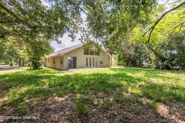 7030 Livingstone Ln, Melbourne, FL 32904 - view of green lawn featuring french doors