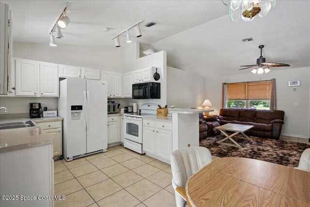 965 19th St SW, Vero Beach, FL 32962 - kitchen featuring white appliances, a sink, rail lighting, open floor plan, and light tile patterned flooring