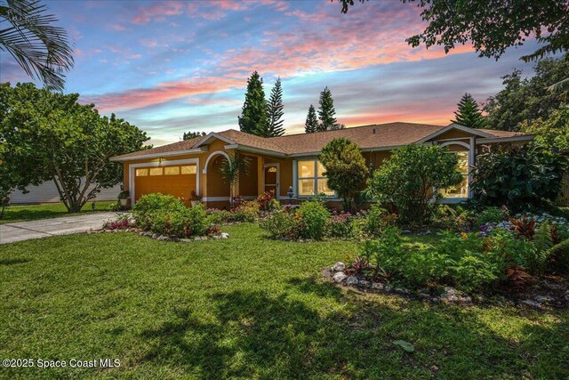 965 19th St SW, Vero Beach, FL 32962 - ranch-style home with an attached garage, a lawn, concrete driveway, and stucco siding