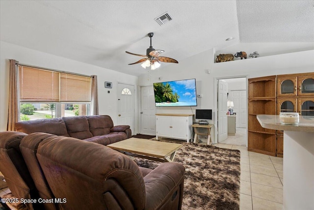 965 19th St SW, Vero Beach, FL 32962 - living area with vaulted ceiling, a ceiling fan, light tile patterned flooring, and a textured ceiling