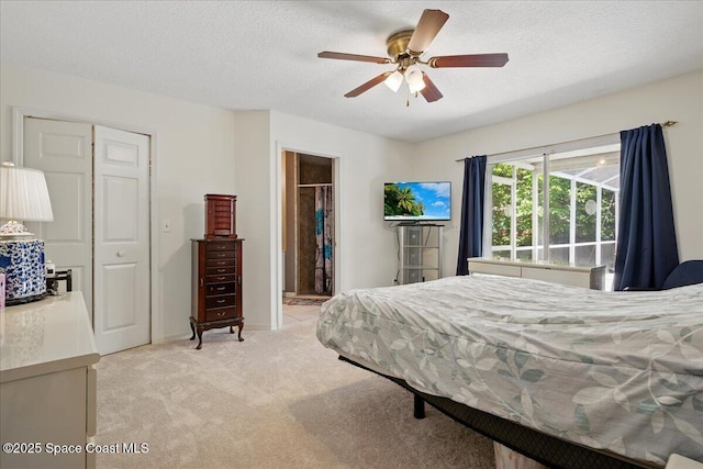 965 19th St SW, Vero Beach, FL 32962 - bedroom featuring light colored carpet, a spacious closet, a closet, a textured ceiling, and ceiling fan