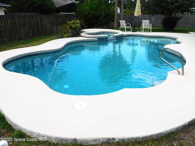 174 Peckham St NE, Palm Bay, FL 32907 - view of pool featuring a fenced backyard, a patio area, and a pool with connected hot tub