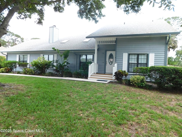 174 Peckham St NE, Palm Bay, FL 32907 - view of front of house with a chimney and a front yard
