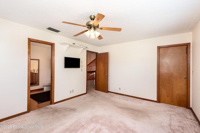 174 Peckham St NE, Palm Bay, FL 32907 - unfurnished bedroom featuring light carpet, baseboards, ensuite bath, and ceiling fan