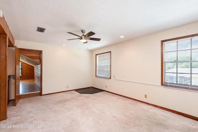 174 Peckham St NE, Palm Bay, FL 32907 - unfurnished room with baseboards, light colored carpet, ceiling fan, and recessed lighting