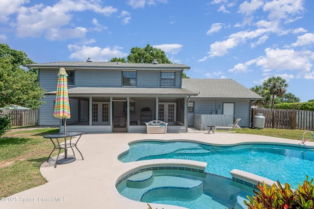 174 Peckham St NE, Palm Bay, FL 32907 - rear view of property with french doors, a pool with connected hot tub, a patio area, and a shingled roof
