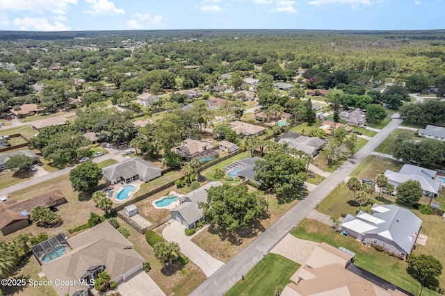 174 Peckham St NE, Palm Bay, FL 32907 - aerial perspective of suburban area with a pool area and a heavily wooded area