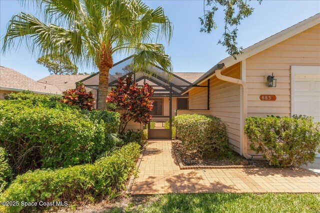 883 Ridge Lake Dr, Melbourne, FL 32940 - property entrance with roof with shingles and a garage