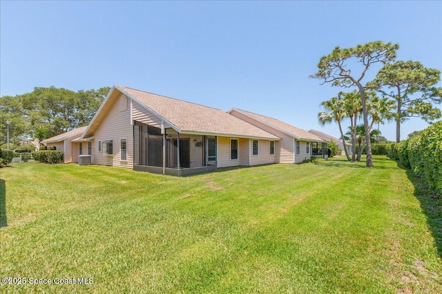 883 Ridge Lake Dr, Melbourne, FL 32940 - rear view of property featuring a yard, a sunroom, and central air condition unit