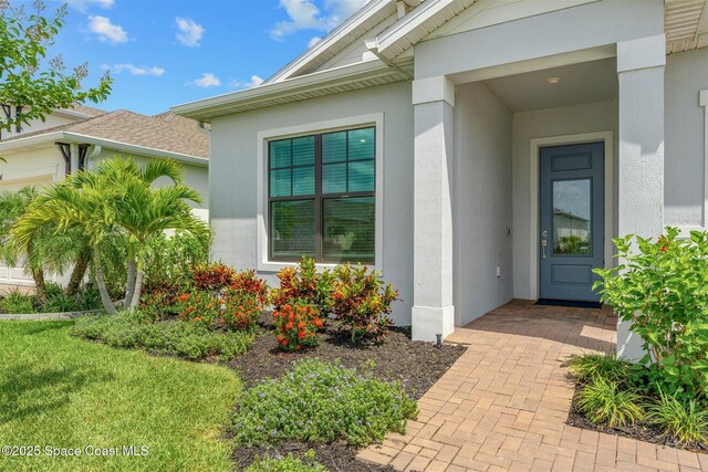 8854 Alister Dr, Melbourne, FL 32940 - property entrance featuring stucco siding