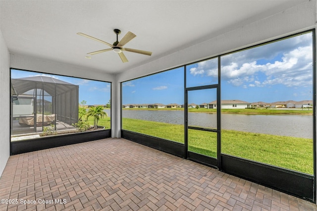 8854 Alister Dr, Melbourne, FL 32940 - unfurnished sunroom with ceiling fan, a water view, and a residential view
