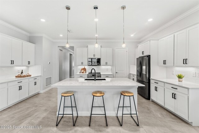 8854 Alister Dr, Melbourne, FL 32940 - kitchen featuring black refrigerator with ice dispenser, a sink, backsplash, a kitchen breakfast bar, and crown molding