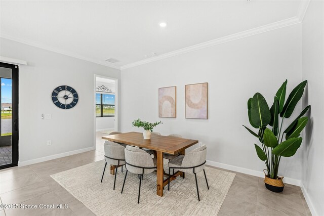 8854 Alister Dr, Melbourne, FL 32940 - dining room featuring crown molding, light tile patterned floors, baseboards, and recessed lighting