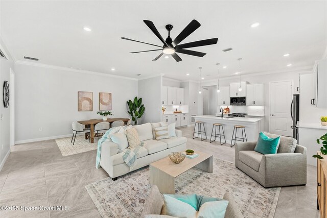 8854 Alister Dr, Melbourne, FL 32940 - living room featuring a ceiling fan, recessed lighting, ornamental molding, and baseboards