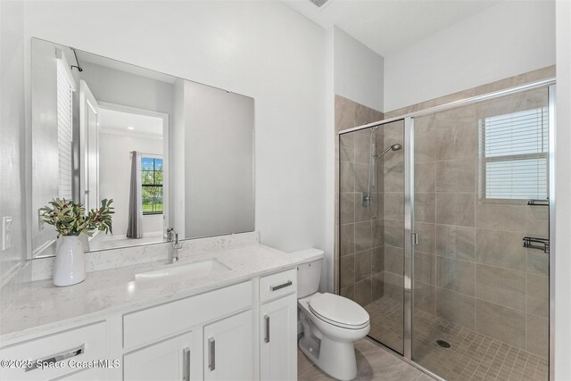 8854 Alister Dr, Melbourne, FL 32940 - bathroom featuring vanity, a shower stall, and toilet