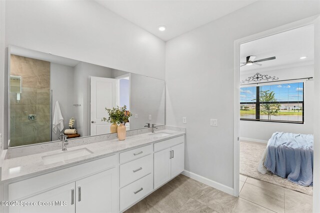 8854 Alister Dr, Melbourne, FL 32940 - bathroom with double vanity, baseboards, tile patterned flooring, a ceiling fan, and a tile shower