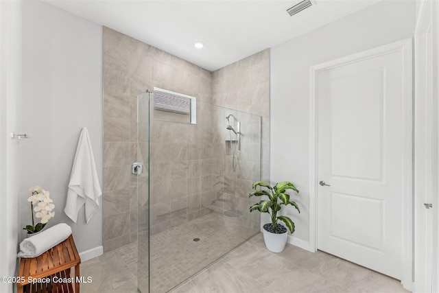 8854 Alister Dr, Melbourne, FL 32940 - bathroom featuring baseboards, walk in shower, tile patterned floors, and recessed lighting