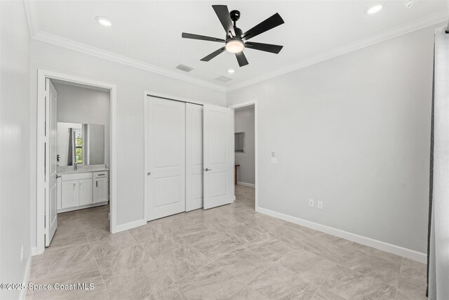 8854 Alister Dr, Melbourne, FL 32940 - unfurnished bedroom with a closet, connected bathroom, crown molding, baseboards, and recessed lighting