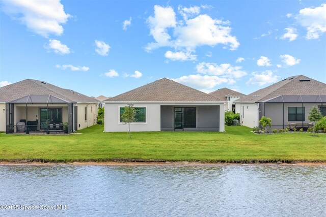 8854 Alister Dr, Melbourne, FL 32940 - back of house featuring a water view, a lawn, stucco siding, and a lanai
