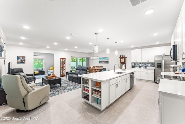 916 Corbin Cir SW, Palm Bay, FL 32908 - kitchen featuring stainless steel appliances, a sink, open floor plan, light countertops, and recessed lighting