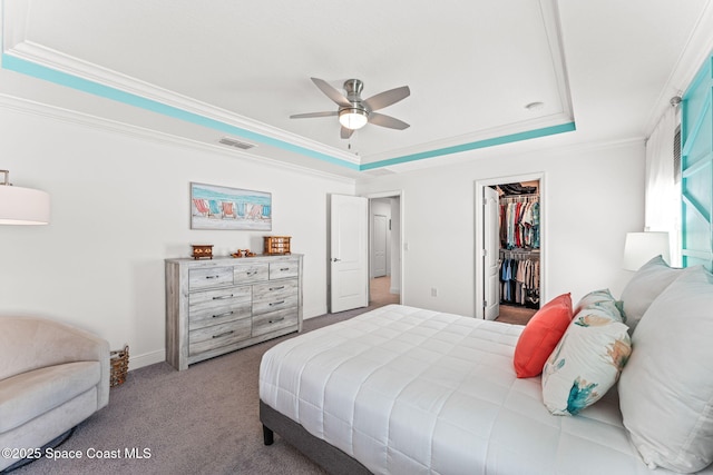 916 Corbin Cir SW, Palm Bay, FL 32908 - bedroom with a raised ceiling, ornamental molding, carpet, a walk in closet, and a closet