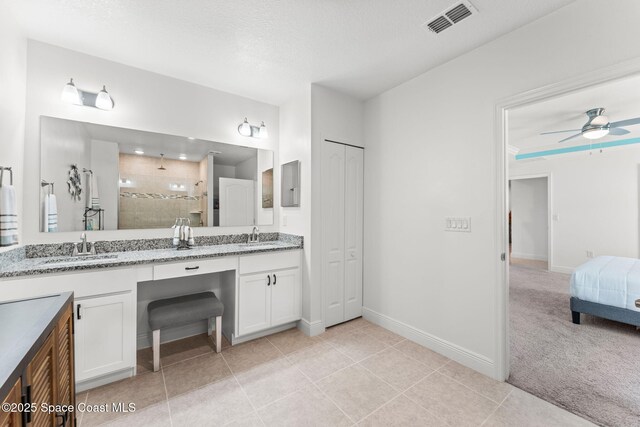 916 Corbin Cir SW, Palm Bay, FL 32908 - full bath featuring tiled shower, ceiling fan, baseboards, double vanity, and tile patterned floors