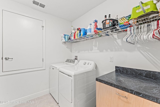 916 Corbin Cir SW, Palm Bay, FL 32908 - laundry room featuring washer and clothes dryer, light tile patterned floors, and baseboards