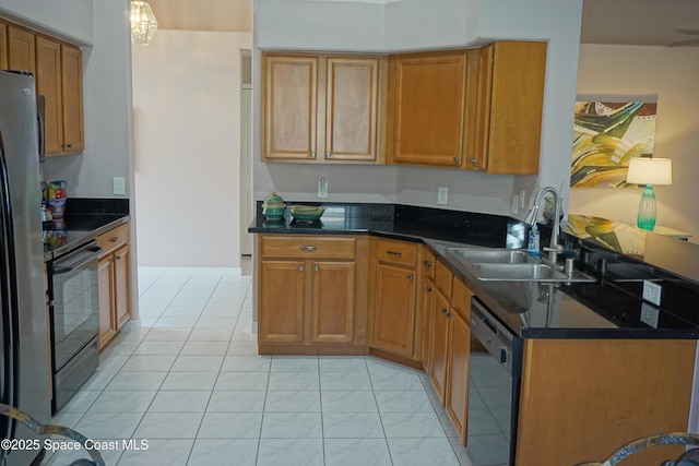 kitchen featuring black appliances, a sink, brown cabinets, and dark stone counters