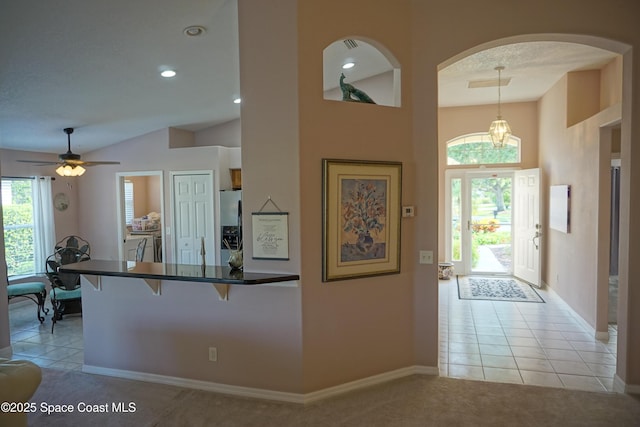 foyer with arched walkways, light tile patterned flooring, baseboards, recessed lighting, and a ceiling fan