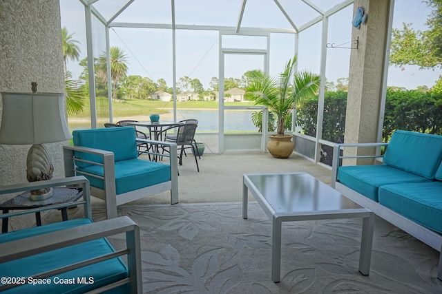 sunroom / solarium featuring an outdoor living space and a water view