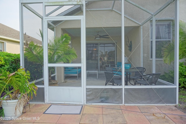 doorway to property with stucco siding, a patio, and a ceiling fan