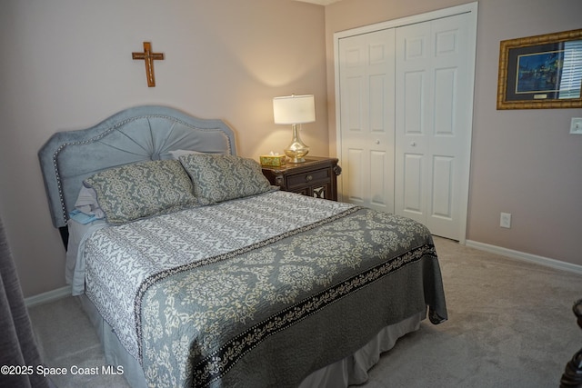 bedroom featuring light colored carpet, a closet, and baseboards