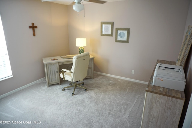 home office with a ceiling fan, light carpet, and baseboards