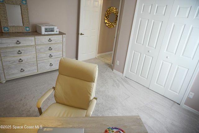 sitting room featuring light colored carpet and baseboards