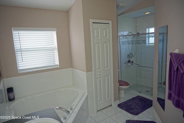 full bathroom featuring a closet, a stall shower, and a garden tub