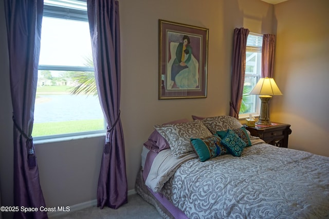 carpeted bedroom featuring baseboards