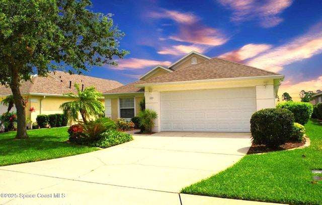 ranch-style home featuring a garage, a yard, stucco siding, and concrete driveway