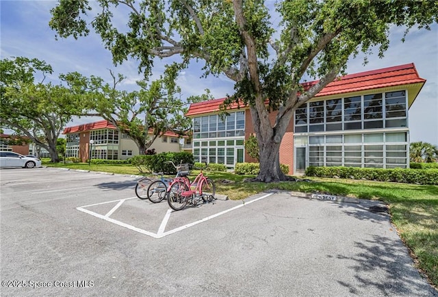 18 Vista Palm Ln Unit 102, Vero Beach, FL 32962 - view of property featuring uncovered parking