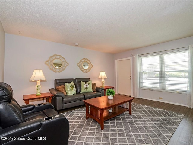 18 Vista Palm Ln Unit 102, Vero Beach, FL 32962 - living room featuring wood finished floors, a textured ceiling, and baseboards
