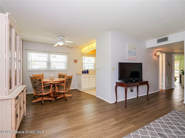 18 Vista Palm Ln Unit 102, Vero Beach, FL 32962 - dining space featuring wood finished floors, a textured ceiling, ceiling fan, and baseboards