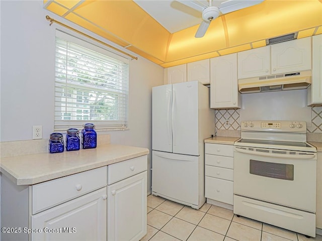 18 Vista Palm Ln Unit 102, Vero Beach, FL 32962 - kitchen featuring white appliances, under cabinet range hood, light tile patterned flooring, ceiling fan, and white cabinetry