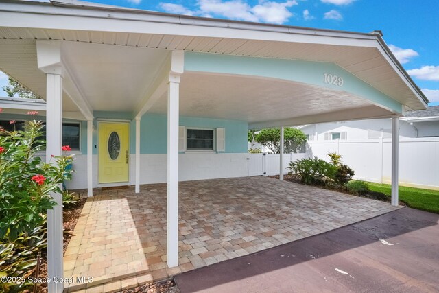 1029 Palmer Rd, Rockledge, FL 32955 - view of patio featuring an attached carport and driveway