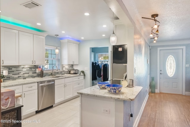 1029 Palmer Rd, Rockledge, FL 32955 - kitchen featuring stainless steel dishwasher, tasteful backsplash, white cabinetry, pendant lighting, and recessed lighting